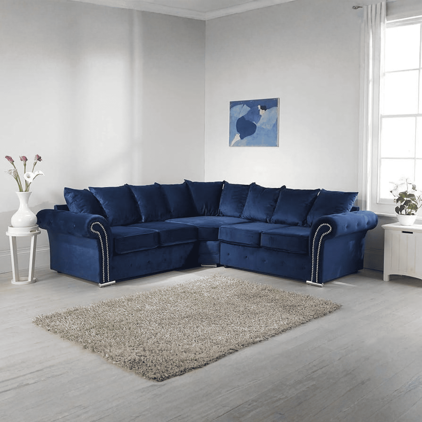 Royal blue corner sofa in a modern living room with plush cushions and stylish decor.